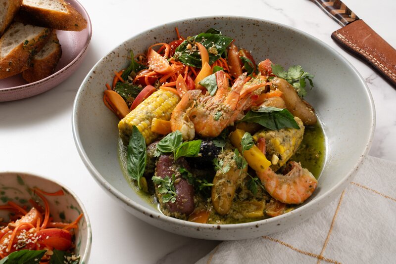 Thai Shrimp Boil with Som Tum Carrot Slaw & Lemongrass-Chili Butter Baguette